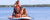 Couple with three kids paddle boarding