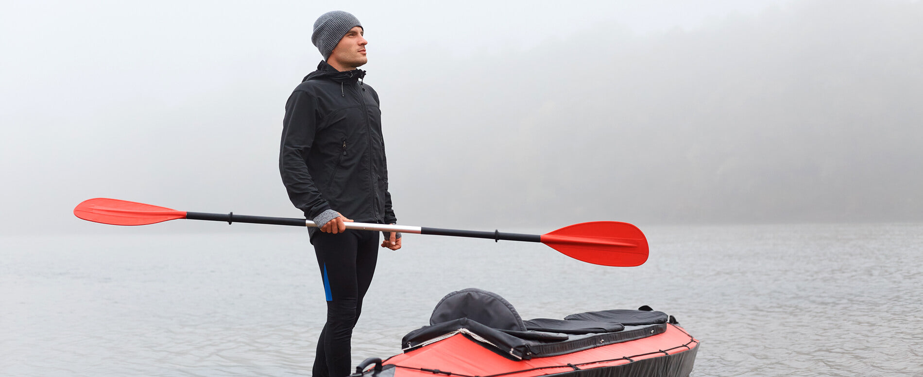Man holding a kayak paddle