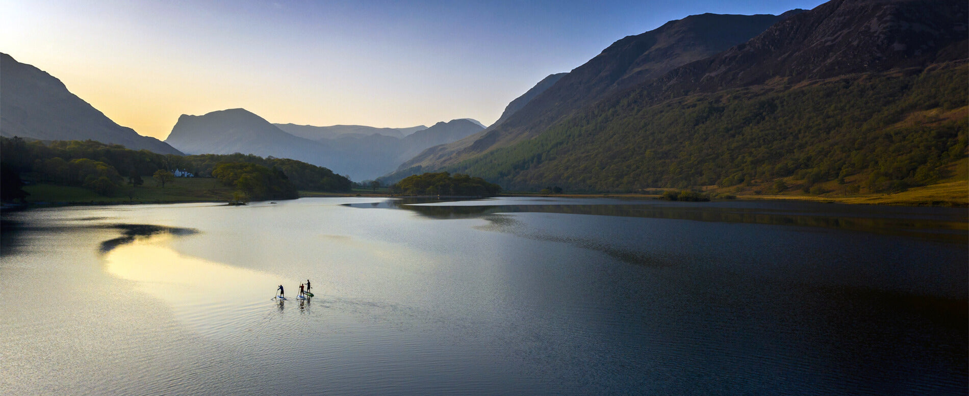 Early morning paddle boarders at Crummock water